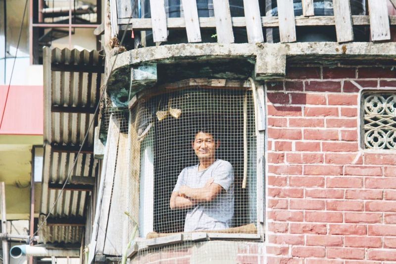 A man looking out of the window from his house in Tuensang during the COVID-19 enforced lockdown in the State earlier this year. (Morung File Photo)